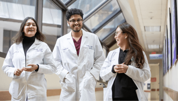 Three physician residents laughing.