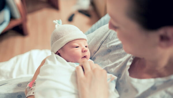 a woman comforting her newborn child