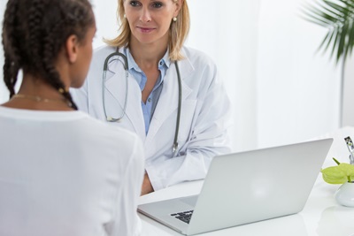 female doctor with young female patient