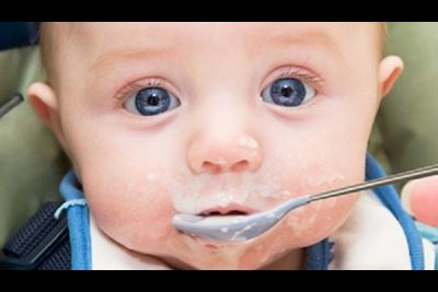 Mommy feeding baby warm cereal