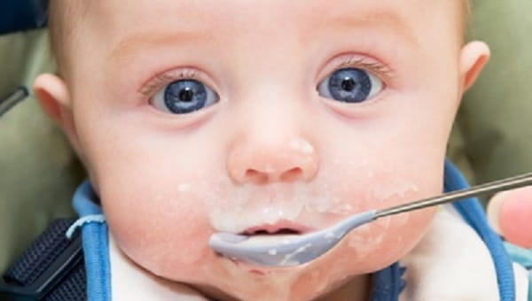 Mommy feeding baby warm cereal