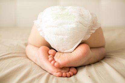 small child is sleeping in a diaper