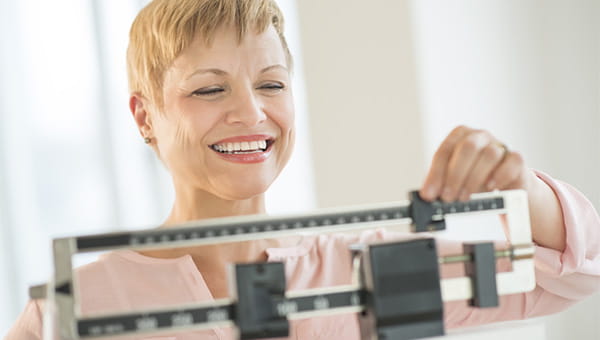 A woman on the scale happy with her weight