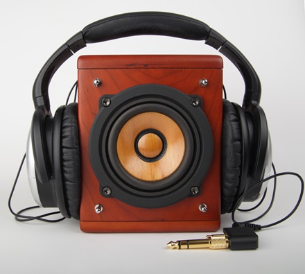 Headphones placed on a square tabletop speaker