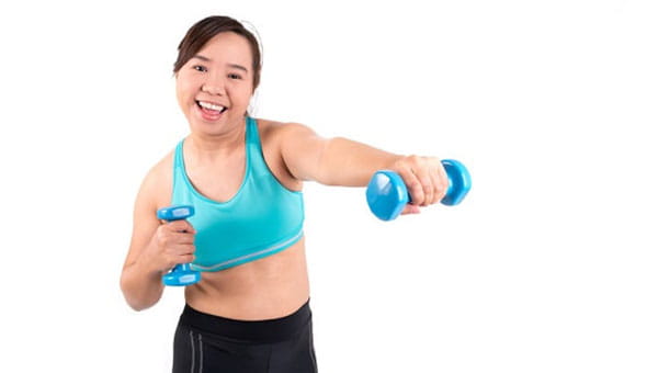 A woman working out with dumbbells