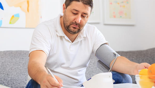 A man is checking his blood pressure.