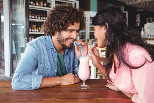 A couple sharing a milkshake
