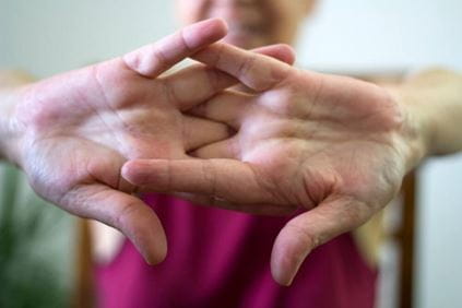 Person pushing their hands out to crack their knuckles