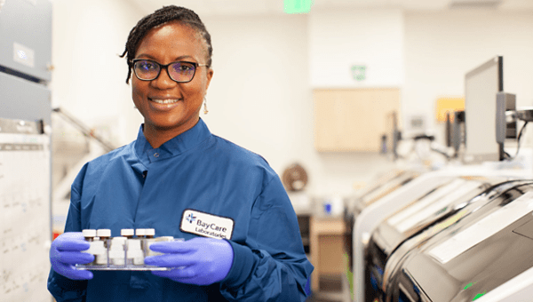 A BayCare clinical professional smiles in a clinical setting.