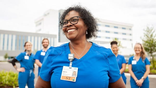five baycare team members smiling outside of hospital