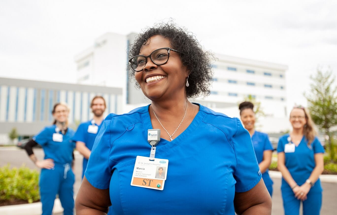 five baycare team members smiling outside of hospital