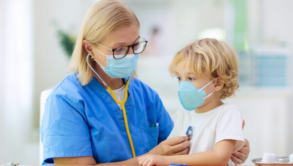 Female medical provider listening to a young patient's heart