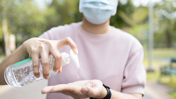 man using hand sanitizer