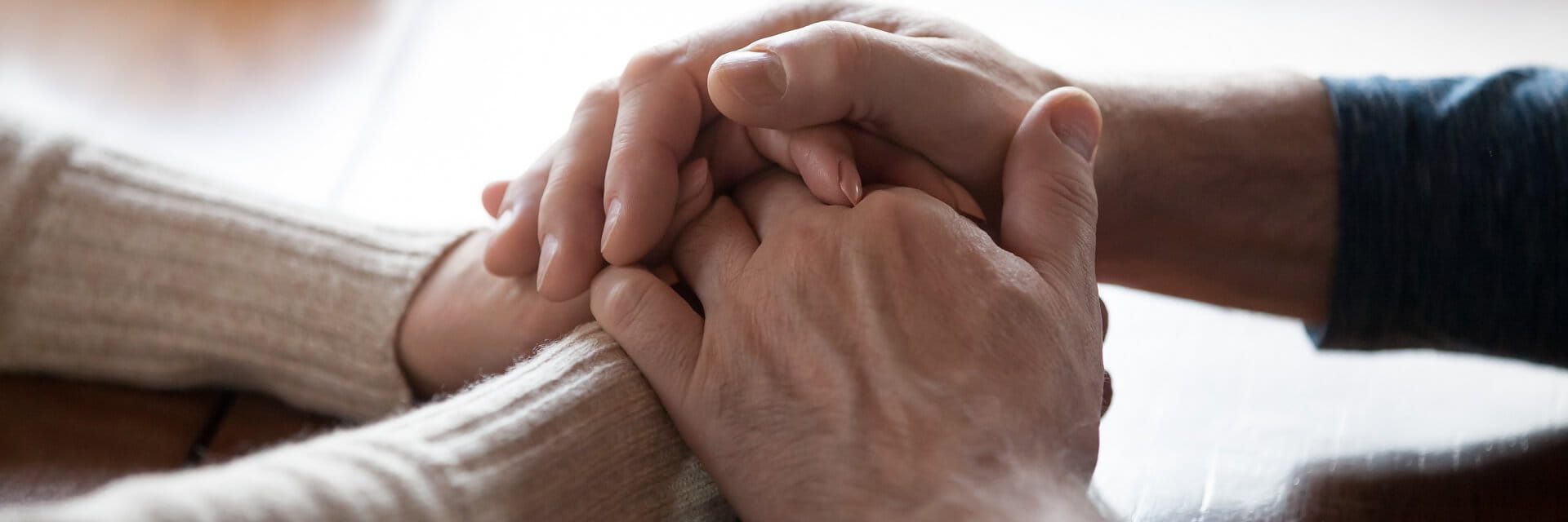 Two people are holding hands.