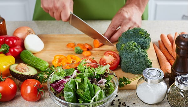 someone chopping vegetables in the kitchen