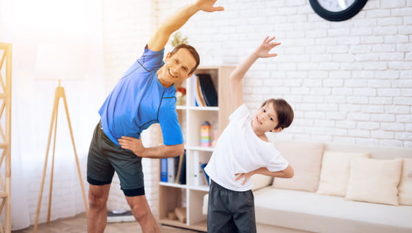 The man and the boy are engaged in stretching