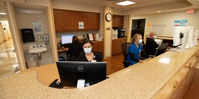 Front desk staff working behind a desk at BayCare Alliant Hospital.