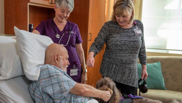 Suncoast Hospice of Hillsborough Inpatient Care St. Joseph's Hospital Suncoast Hospice patient with a therapy dog.