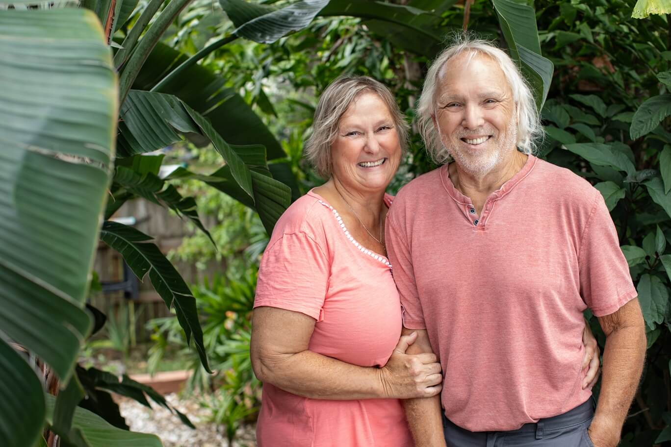 happy older couple smiling outdoors for a photo