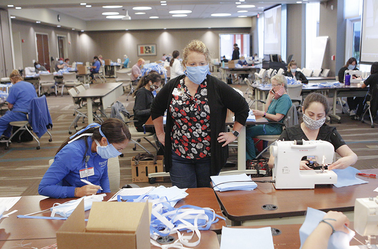 Group of team members assembling masks for health care providers
