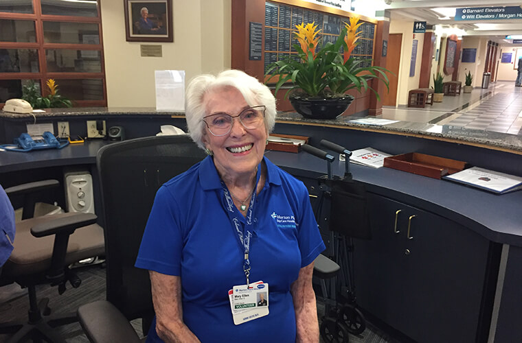 BayCare Volunteer Mary Ellen sitting at reception desk