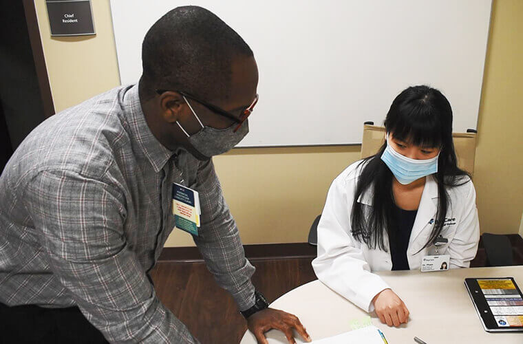 WHH female resident working with residency faculty