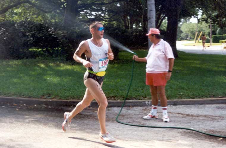 In 1991, a good neighbor to the St. Anthony’s Triathlon refreshes athletes buy spraying them with water from a personal hose.