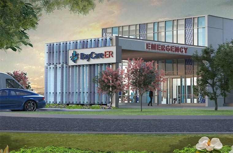 An artist's rendering depicts a two-story building with floor-to-ceiling windows, of varying clarity and color patterns. An awning reaches toward the foreground, with signage displaying the words "EMERGENCY" and "BayCare ER." A sunset sky and green foliage can be seen in the background and foreground, respectively.