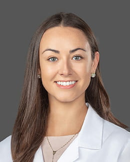 Dr. Christina Rolquin's headshot in a lab coat 