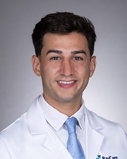 Headshot of Logan Primeaux, MD in a lab coat
