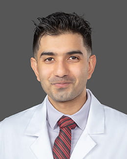 Dr. Oneeb Tahir's headshot wearing a lab coat 