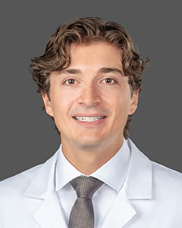 Dr. Teo Fritzke's headshot wearing a lab coat 