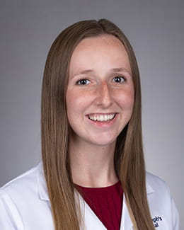 Kenzie Keeney's headshot in a lab coat