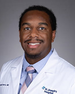 Ronald Harris ' headshot in a labcoat