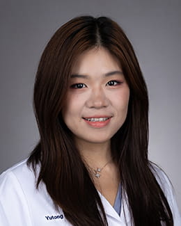 Yutong (Crystal) Li's headshot in a lab coat