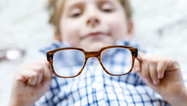 Boy holding eye glasses