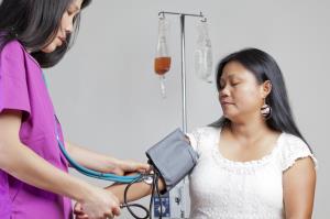 nursing putting on a blood pressure cuff