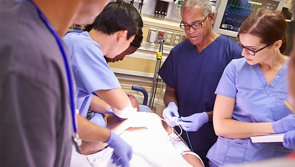 A group of doctors and nurses are treating a patient