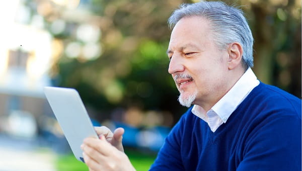 Senior man looking at his tablet