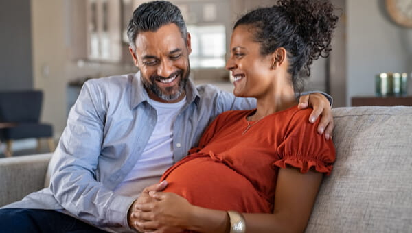 pregnant woman whos husband is touching her belly