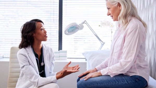 doctor speaking to elderly woman