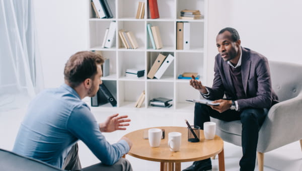 A male patient talks with a male doctor.