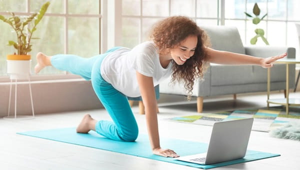 A pregnant woman is doing yoga.