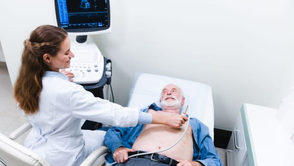 Doctor giving a patient an electrocardiography (EKG) test