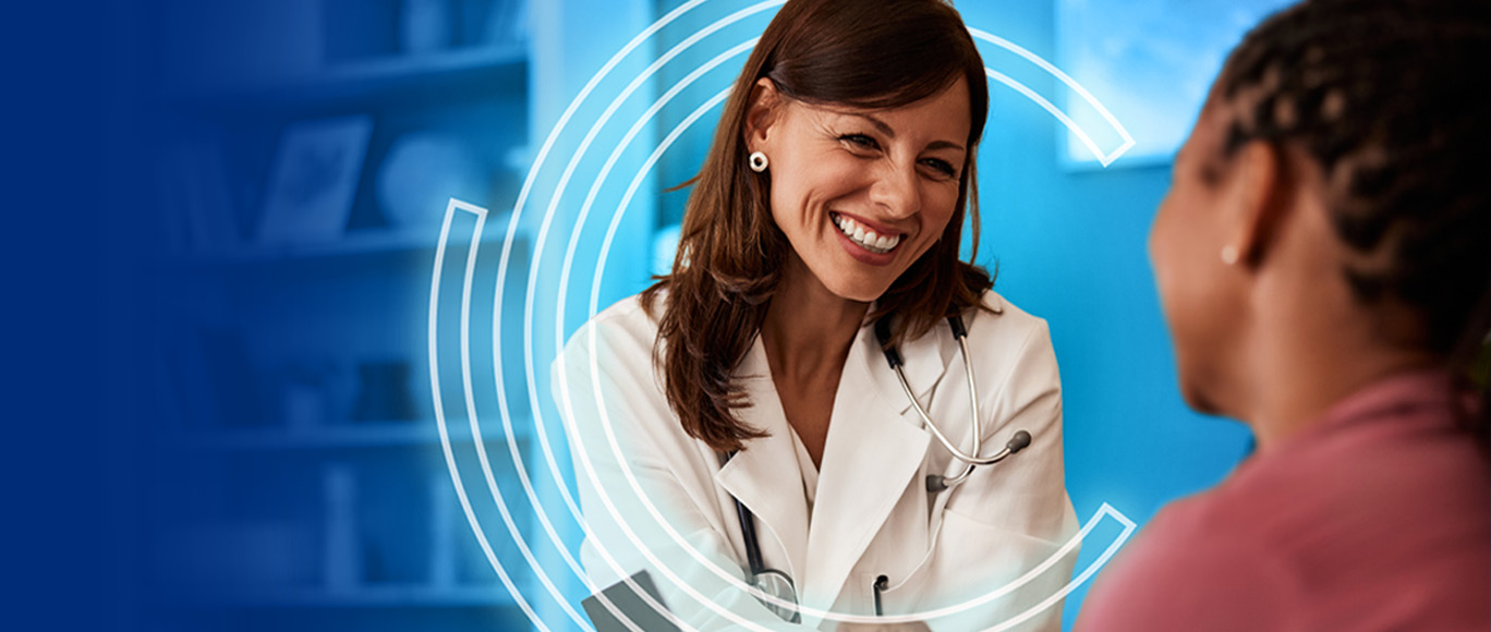 Smiling Doctor talking to a patient within a decorative set of circles.
