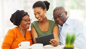 A daughter helps her senior parents with their medical alert system.