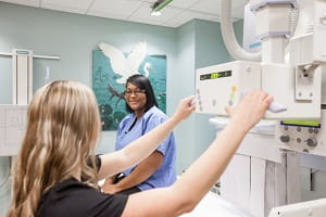 Tech and patient preparing for an x-ray