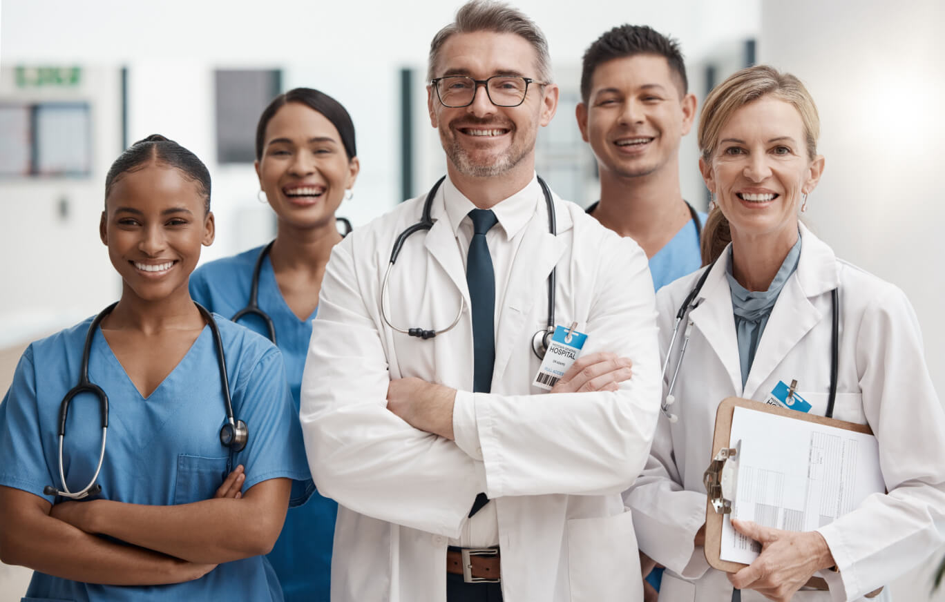 Group of medical professionals smiling together for a photo.