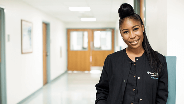 Imaging Tech leaning on a wall