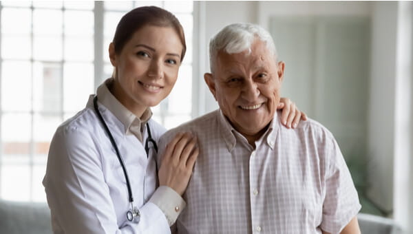 female physician holding the shoulder of her elderly patient